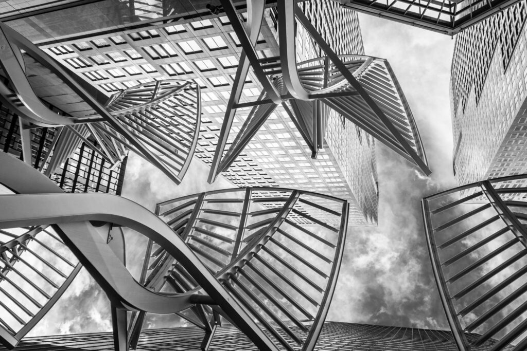 Black and white view of Calgary's modern skyscrapers with distinctive architectural designs.